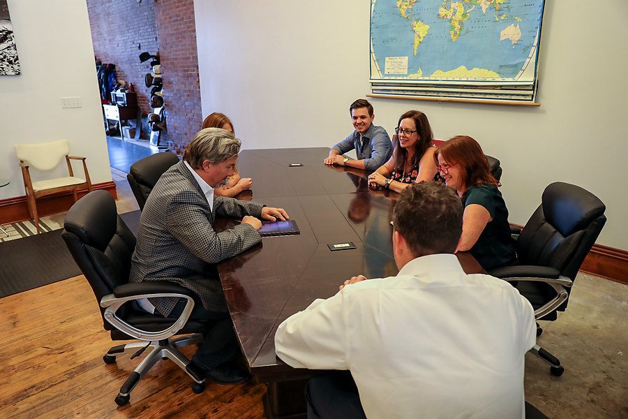 The Net-Vendor team working through customer service accounts at the conference table